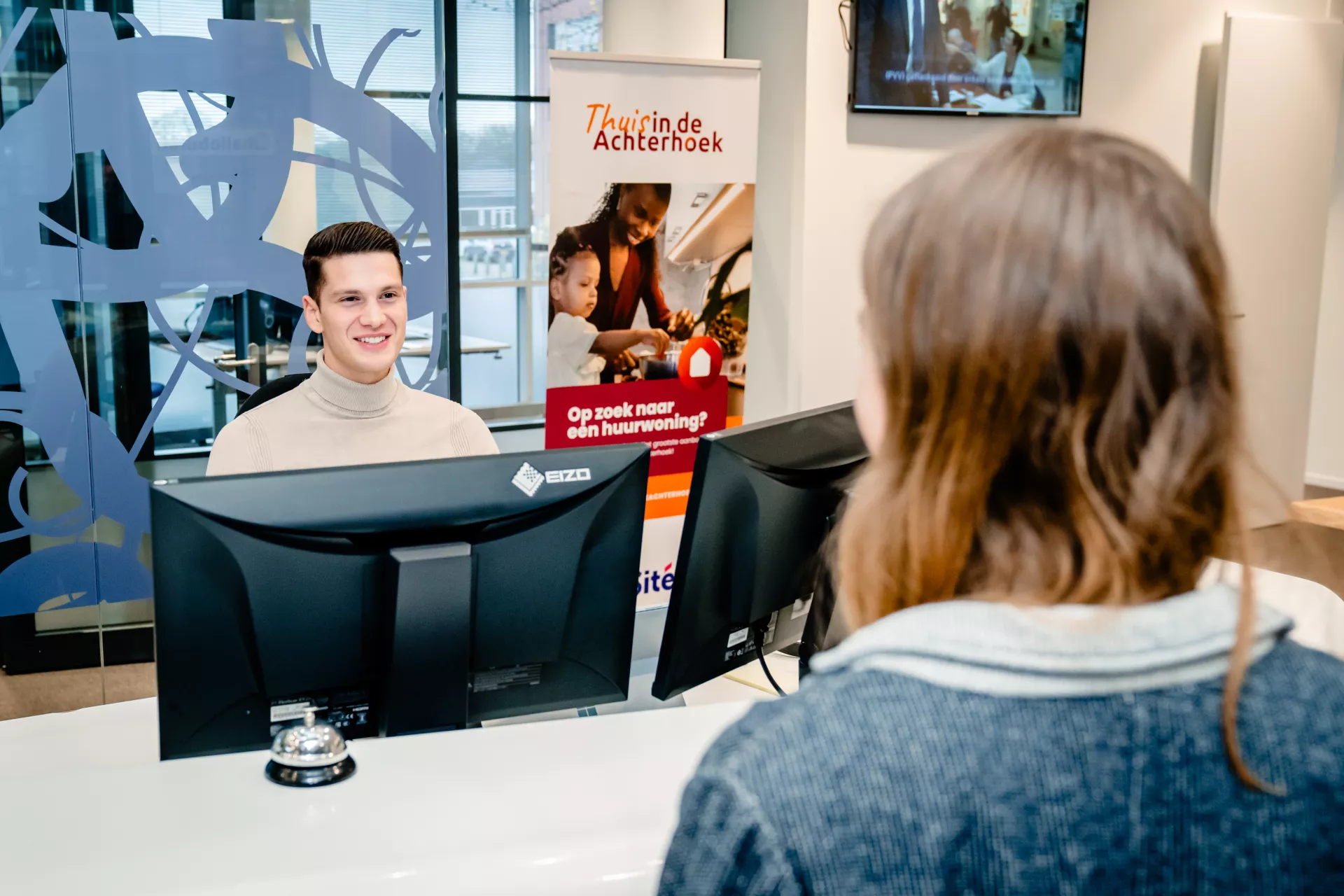 Medewerker Sité Woondiensten staat een huurder te woord.